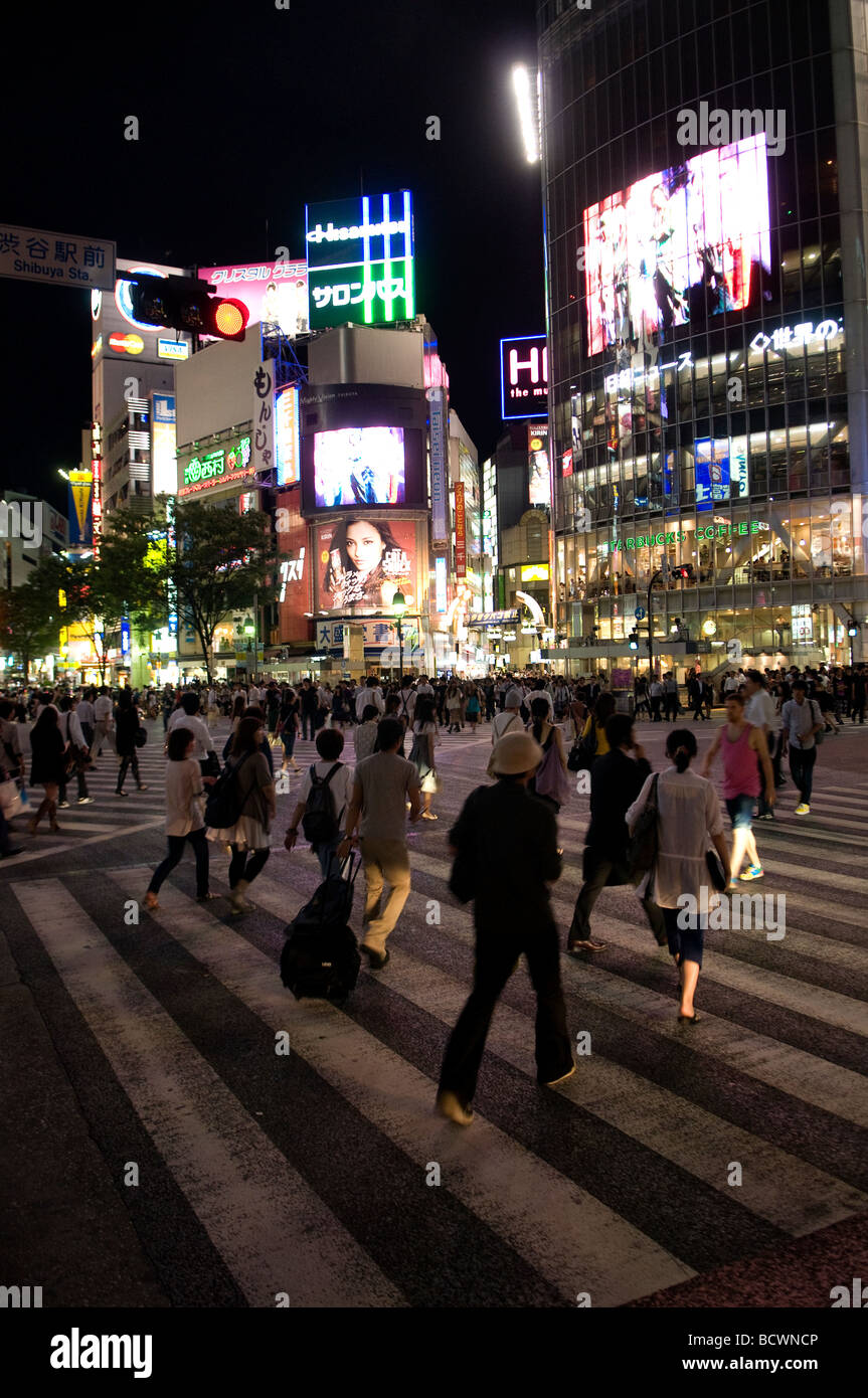 Pedestrians crosing  the street in Shibuya commercial district Tokyo Japan Stock Photo