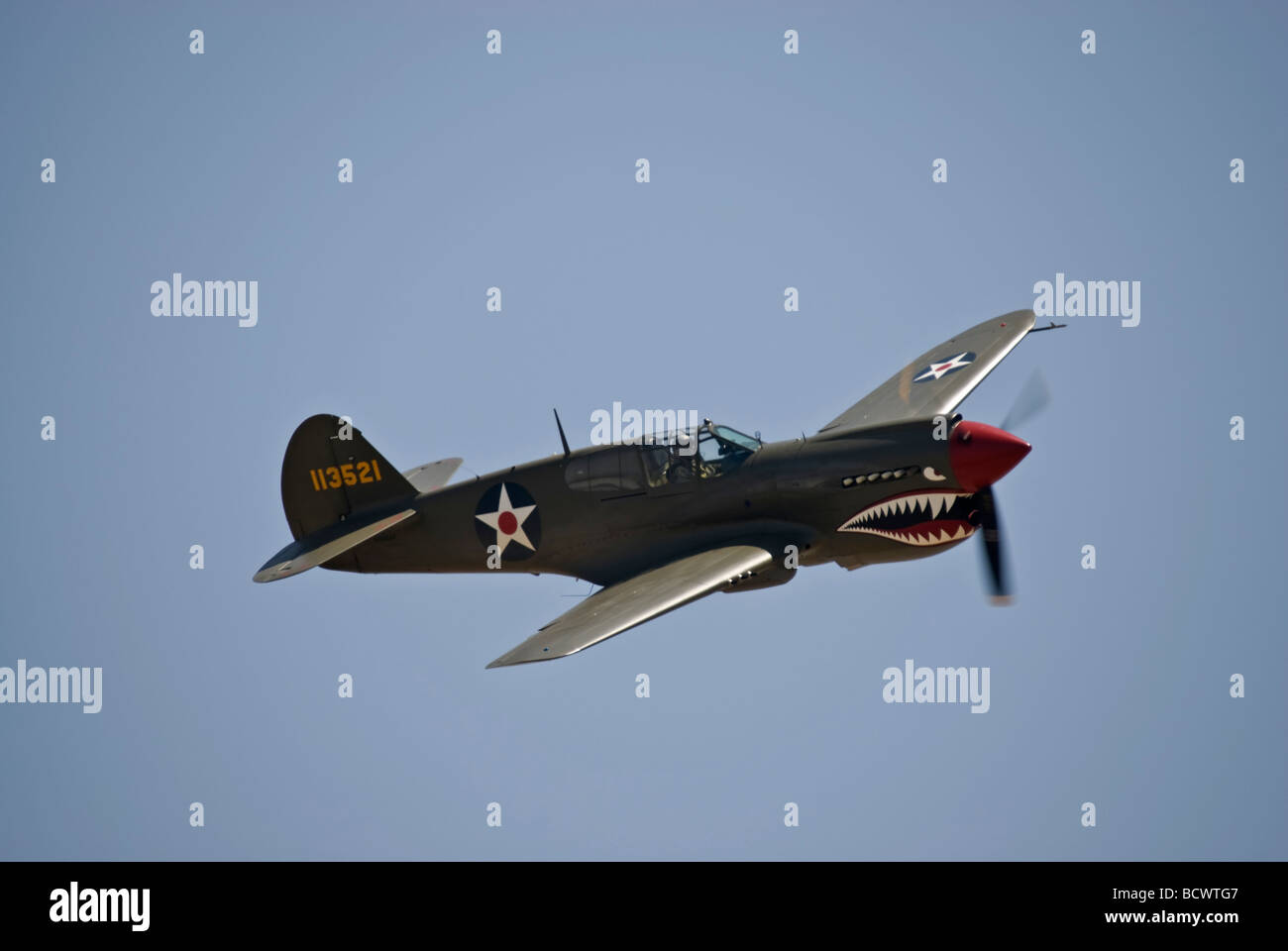 A Curtiss P-40 Warhawk flies at an air show Stock Photo