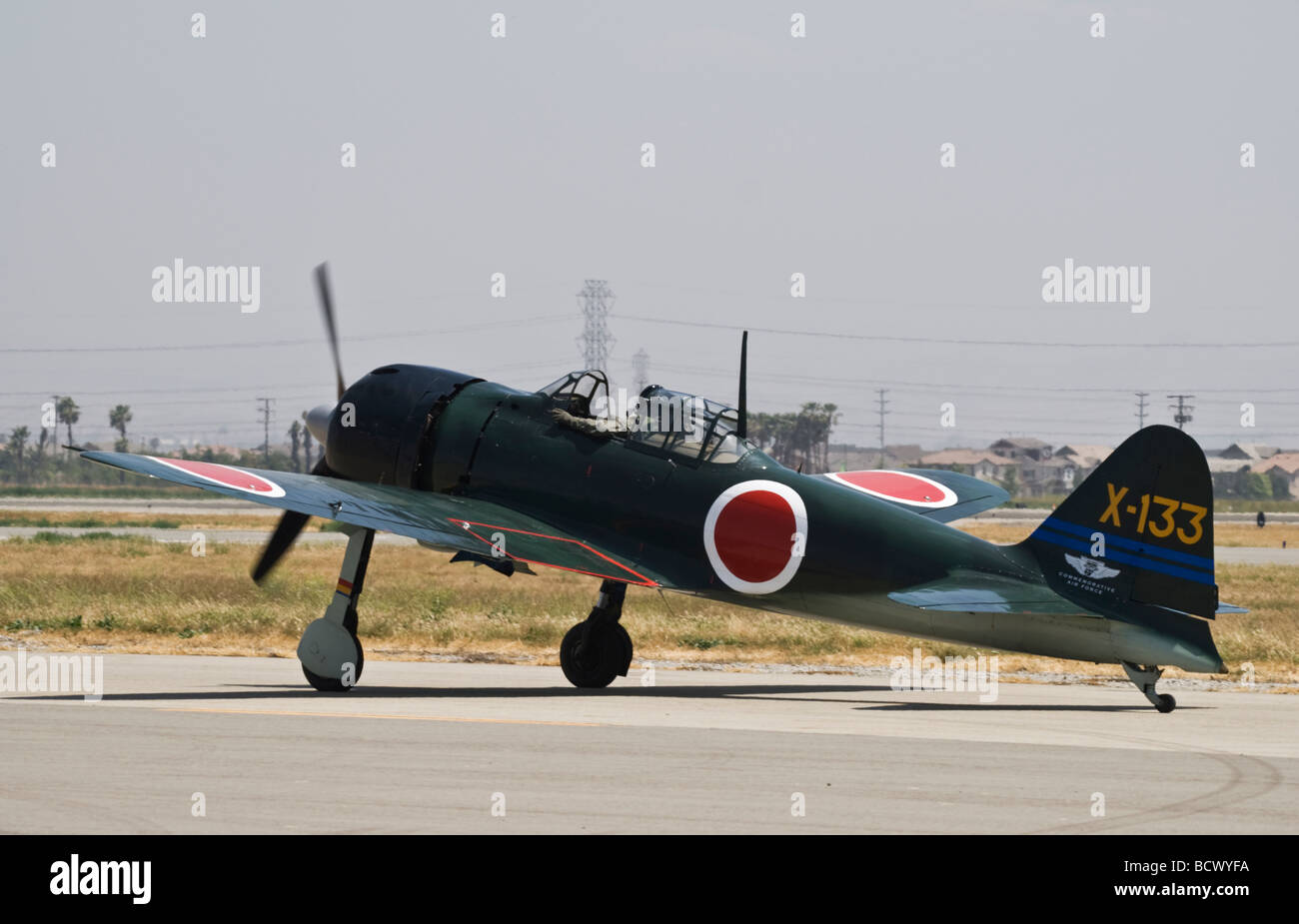 A Mitsubishi A6M5 Zero fighter taxis after flying at an air show.  One of only 3 or 4 airworthy Zero fighters in the world. Stock Photo