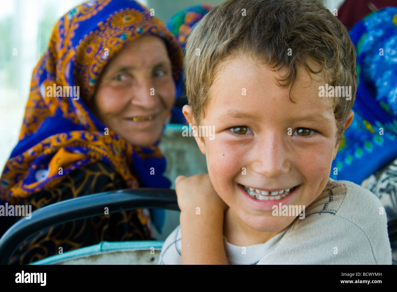 Muslim Woman and Young Boy on a Bus in Mary Turkmenistan Stock Photo