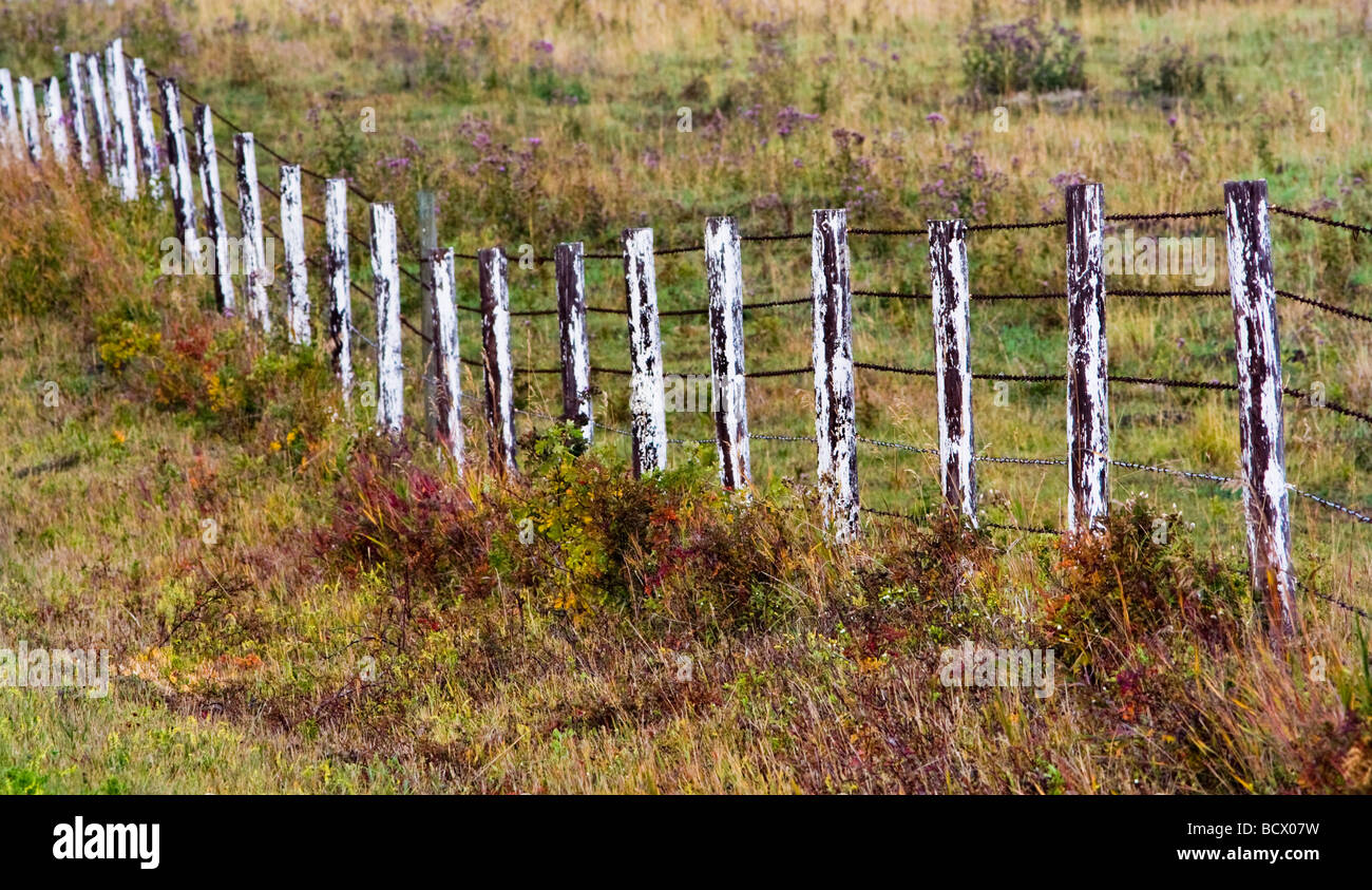 a worn down white fence on a prairie farm. Stock Photo