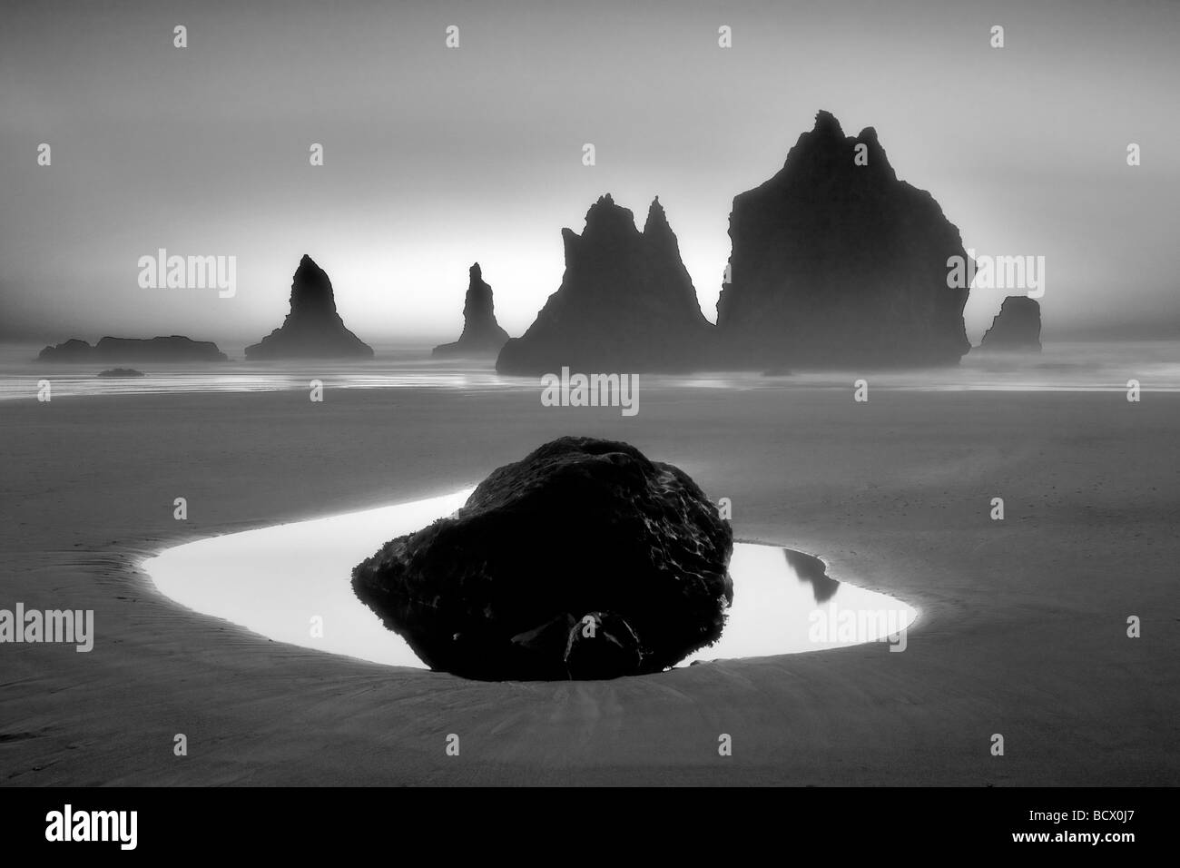 Monolith sea stacks reflecting pool and sunset Samuel H Boardman State Scenic Corridor Oregon Stock Photo