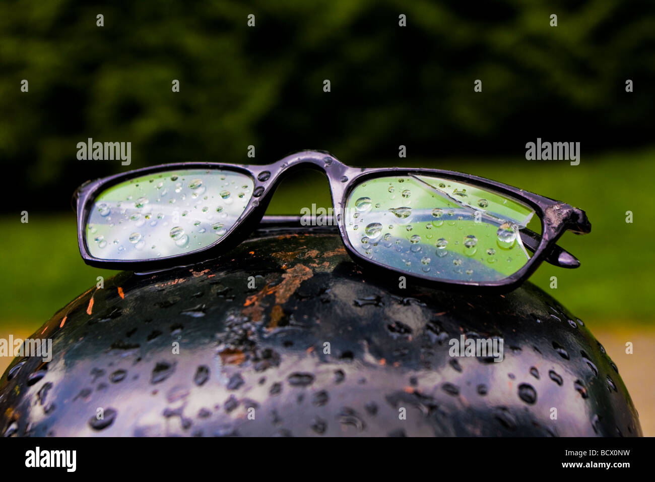 A pair of glasses left behind on a gate post in the Vancouver rain. Stock Photo