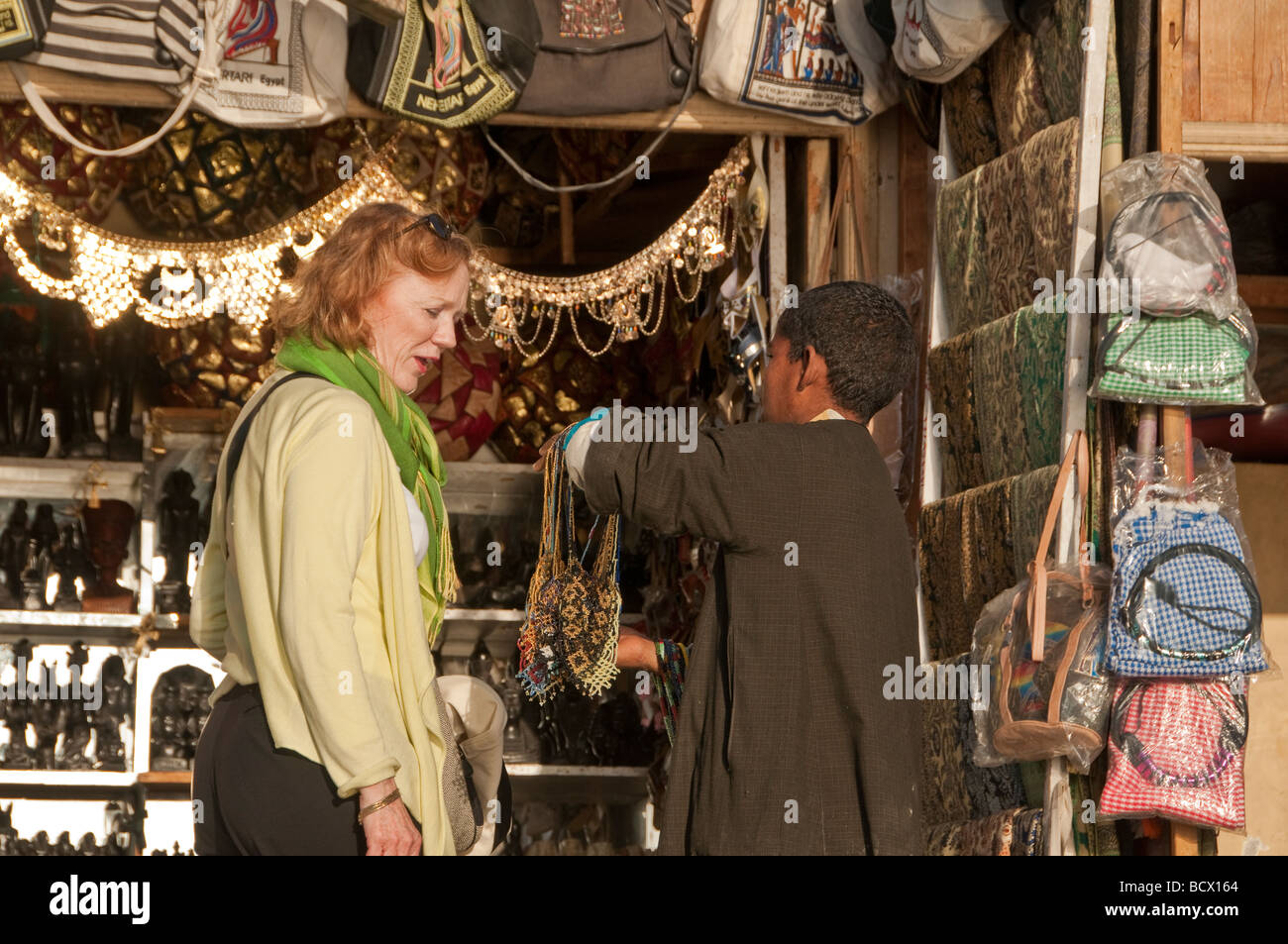 Egypt Kom Ombo village woman tourist red hair looking at souvenirs Stock Photo