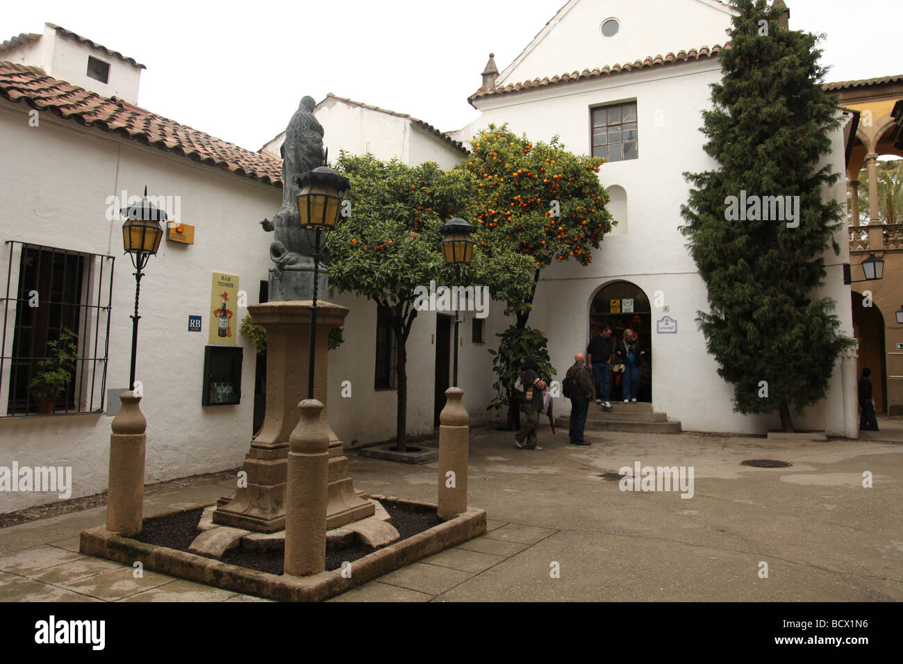 Poble Espanyol (spanish village) buildings white windows orange trees lamps iron railings monument Stock Photo