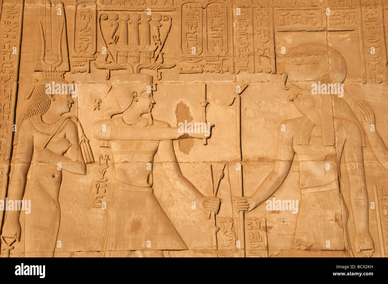 Egypt Kom Ombo temple wall reliefs pharaoh queen honor falcon-headed god Horus weating solar disc Stock Photo