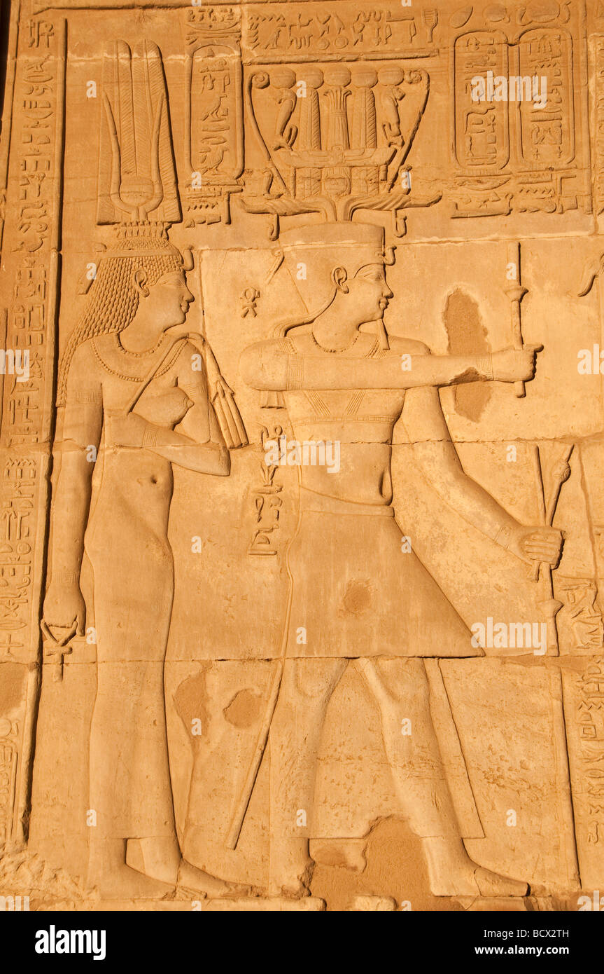 Egypt Kom Ombo temple wall pharaoh queen full length both wear crowns Stock Photo