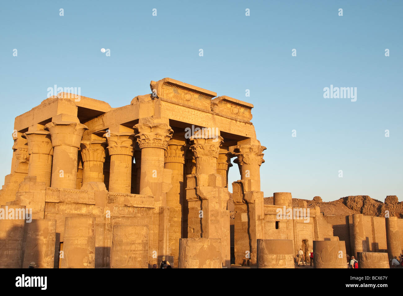 Egypt Kom Ombo temple exterior portrait temple gates late afternoon sun with blue sky seen from left side Stock Photo