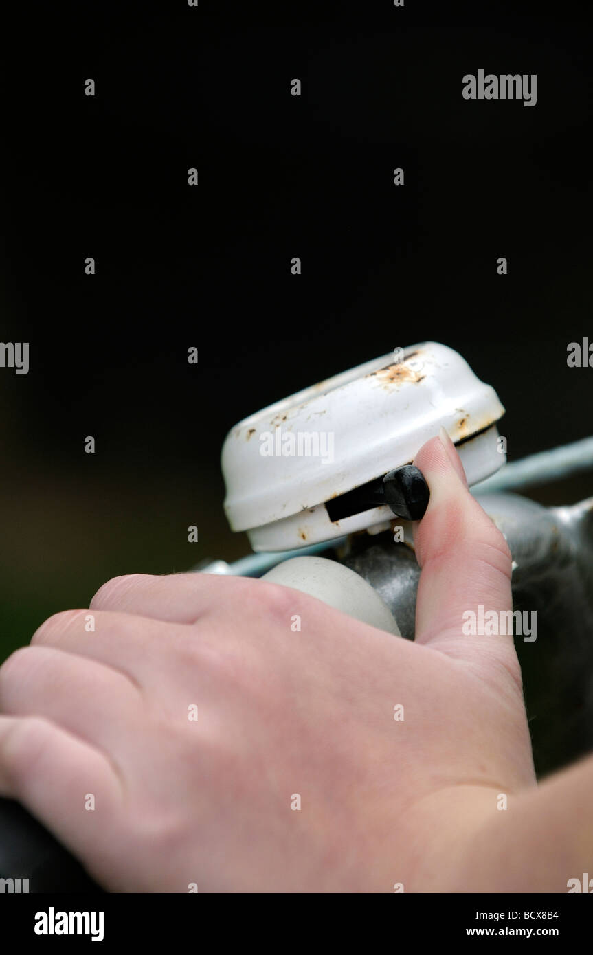 Childs thumb ringing a cycle bell Stock Photo Alamy