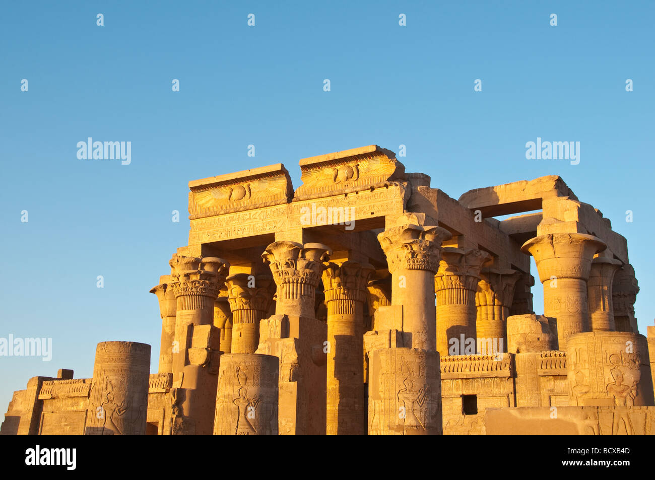 Egypt Kom Ombo temple exterior portrait temple gates late afternoon sun with blue sky seen from right side Stock Photo