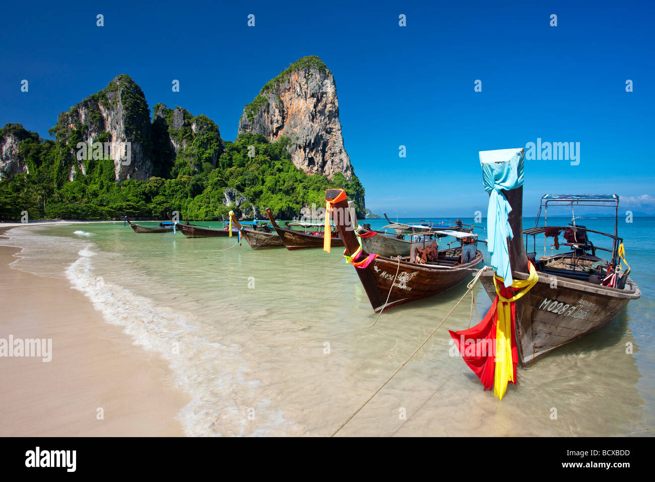 Longtail boats lined up on Railay Beach, Thailand Stock Photo