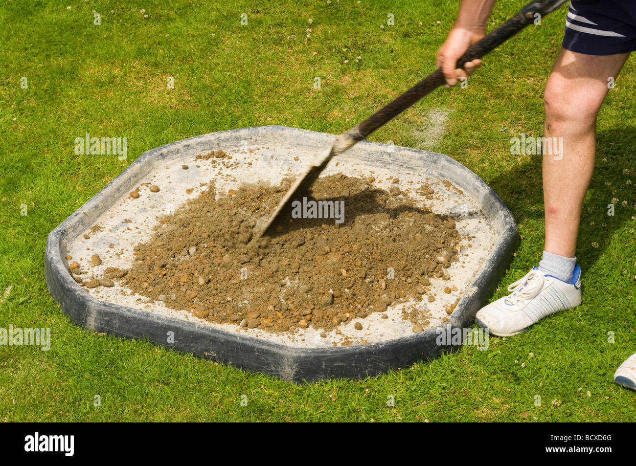 Handyman mixing cement ballast hires stock photography and images Alamy