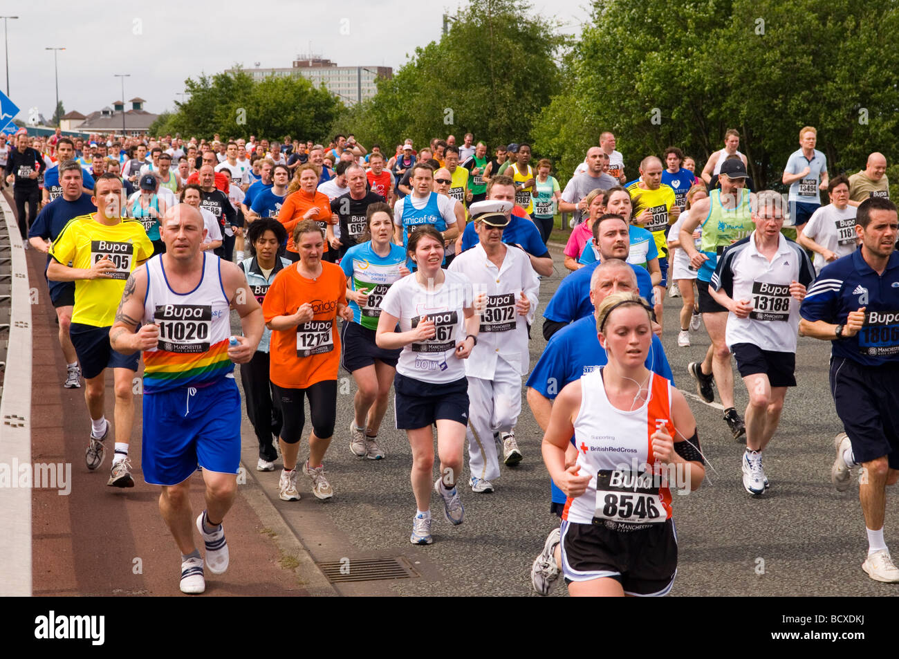 People running a charity fundraising marathon in Manchester UK Stock