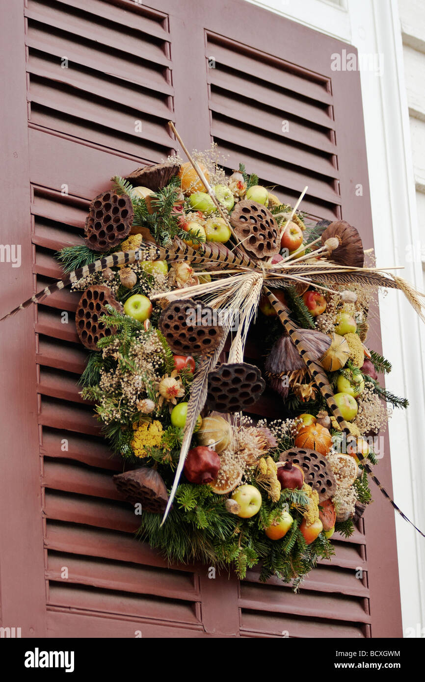 A natural Christmas wreath on a shutter of a house in Colonial Williamsburg Virginia Stock Photo