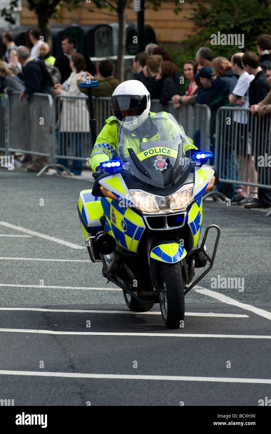 Policeman driving motorbike in Manchester city center UK Stock Photo