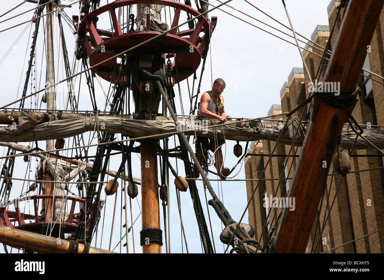 Man working in rigging of Golden Hind replica, London Stock Photo