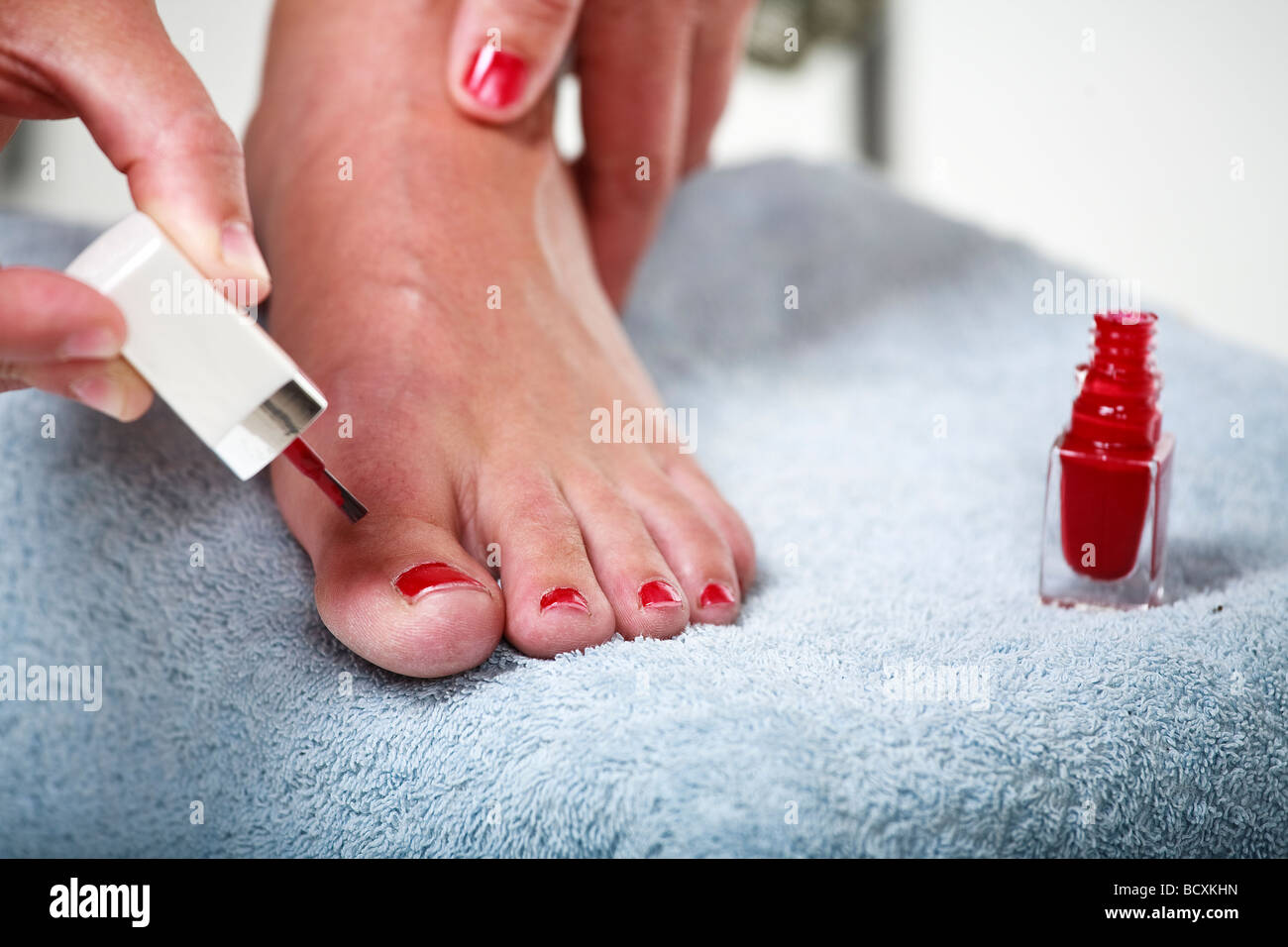 Toes with red nail polish In beauty salon Stock Photo