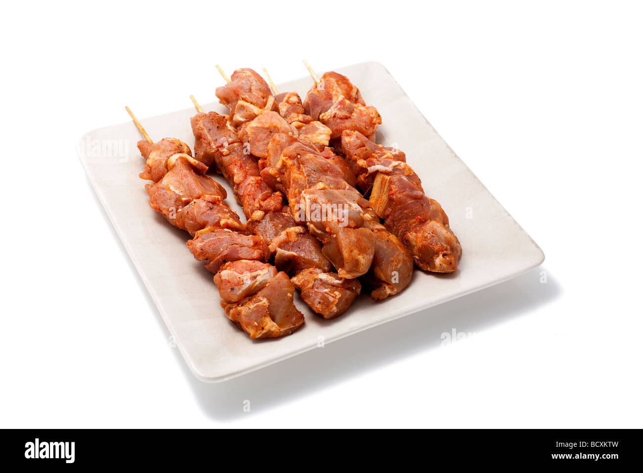 Skewers with meat on a plate Isolated on white Stock Photo