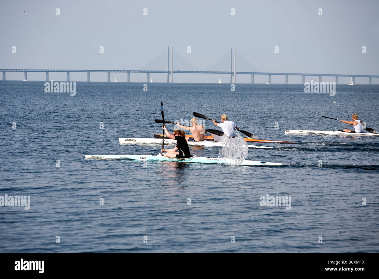 Four kayaks in the sea with oresund bridge in background Stock Photo