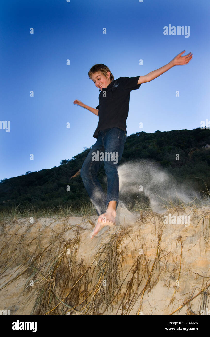 Jumping on sand beach Stock Photo Alamy