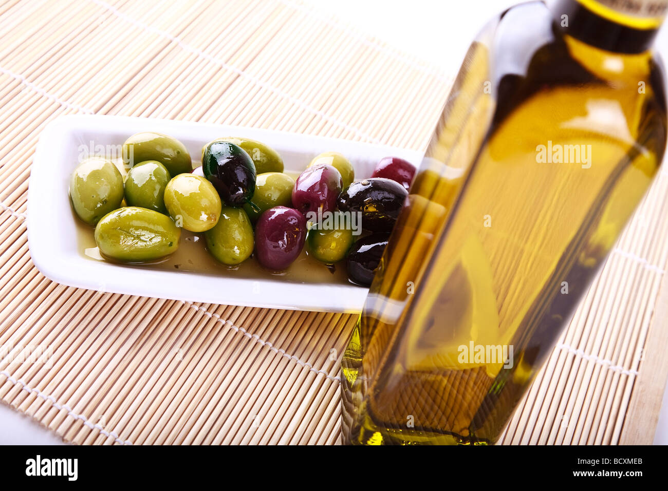 Mixed olives in oil on a plate Stock Photo Alamy