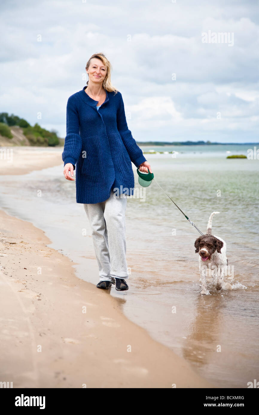 Woman dog walking beach hi-res stock photography and images - Alamy