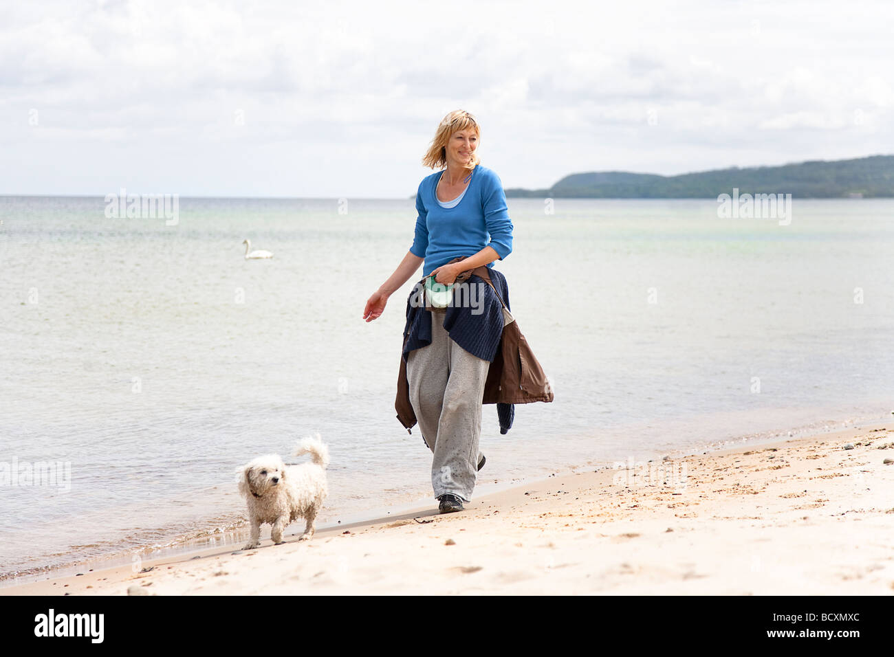 Woman dog walking beach hi-res stock photography and images - Alamy