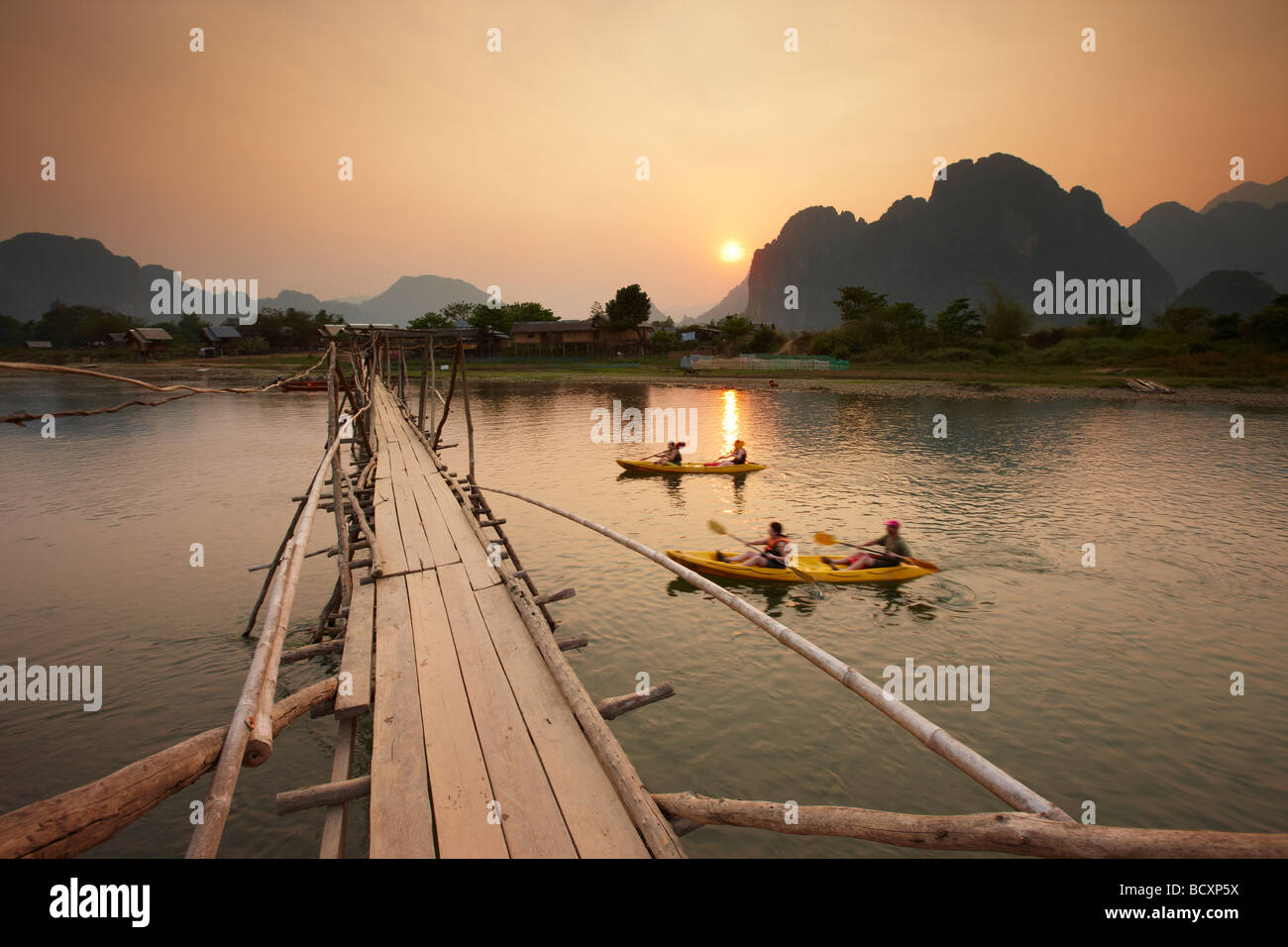 tourists canoeing on the Nam Song River at Vang Vieng, Laos Stock Photo