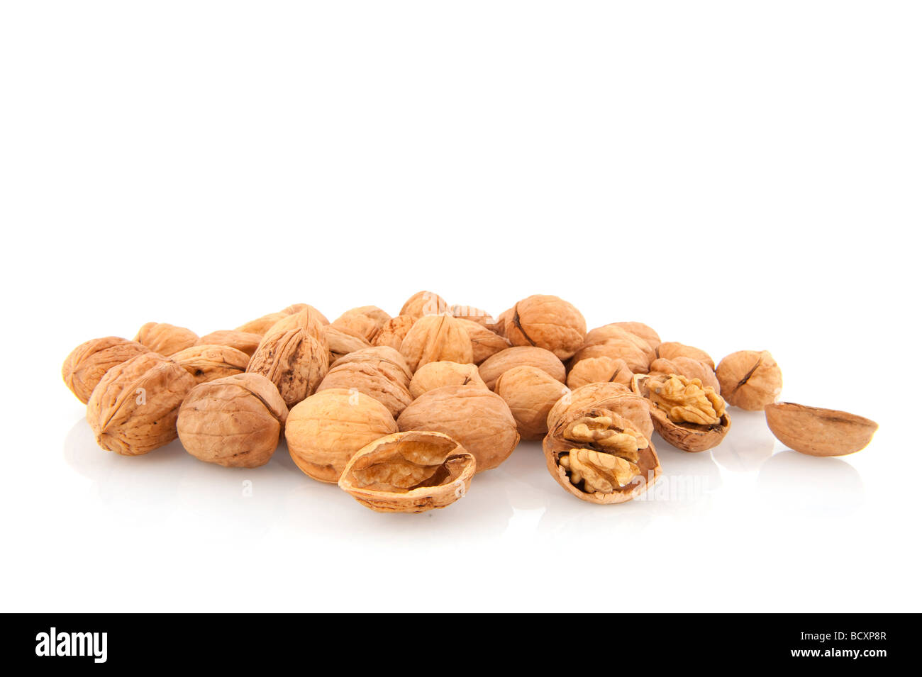 Many tasty whole walnuts isolated over white Stock Photo