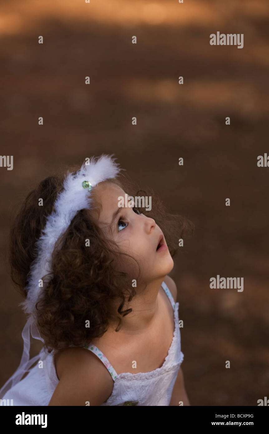 Beautiful girl looking up outdoors Stock Photo - Alamy