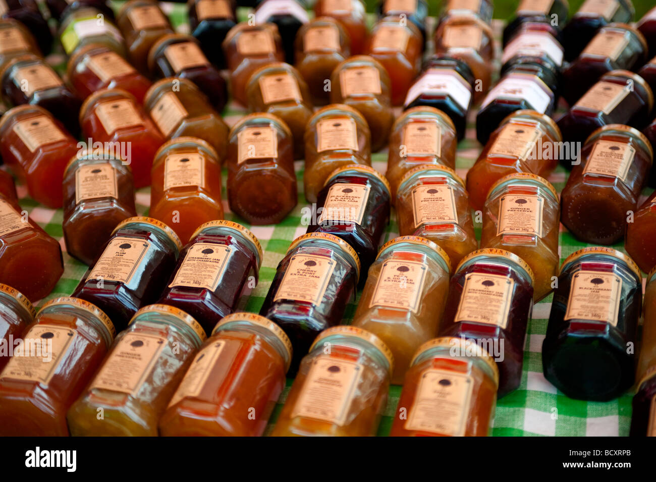 A display of jams and preservatives on a green checked table cloth Stock Photo