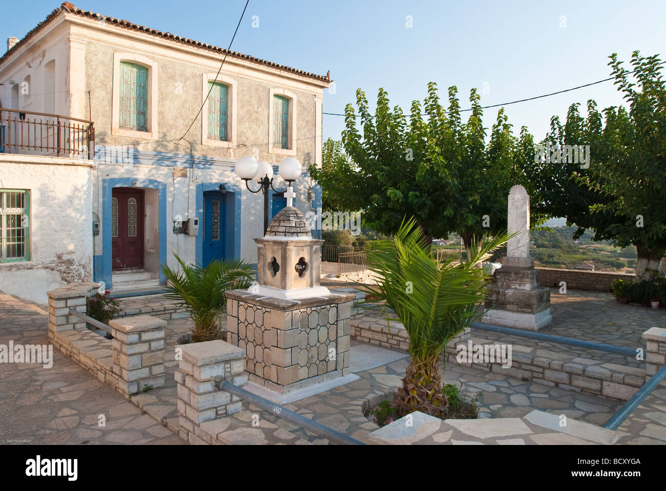 Old stone house in a small square in a village on a greek island Stock Photo
