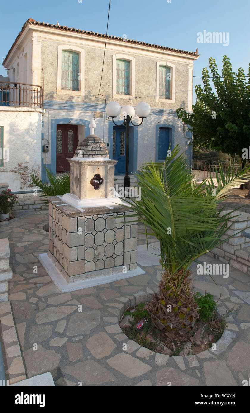 Old stone house in a small square in a village on a greek island Stock Photo