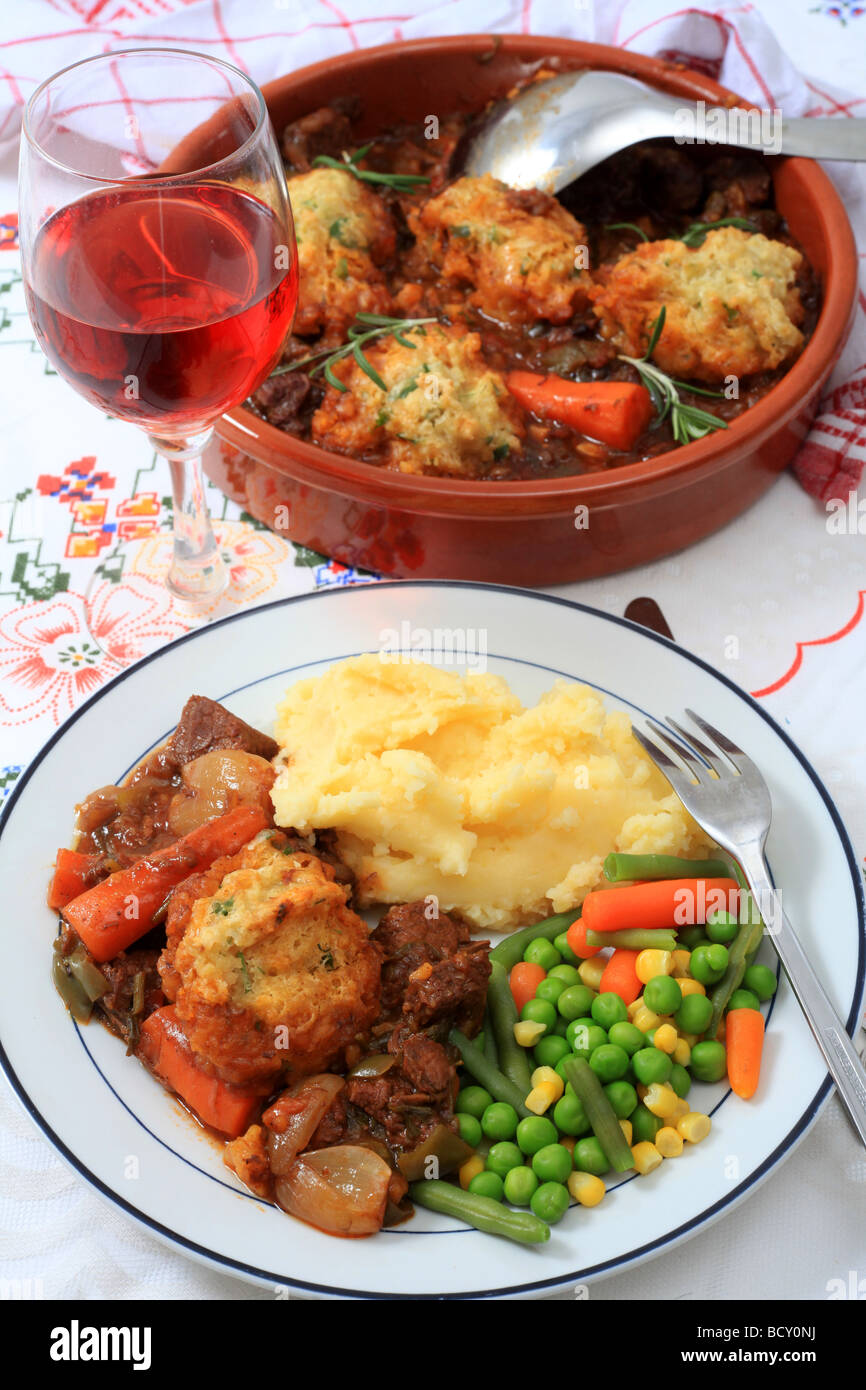 A meal of beef stew with parsley dumplings mashed potatoes and mixed
