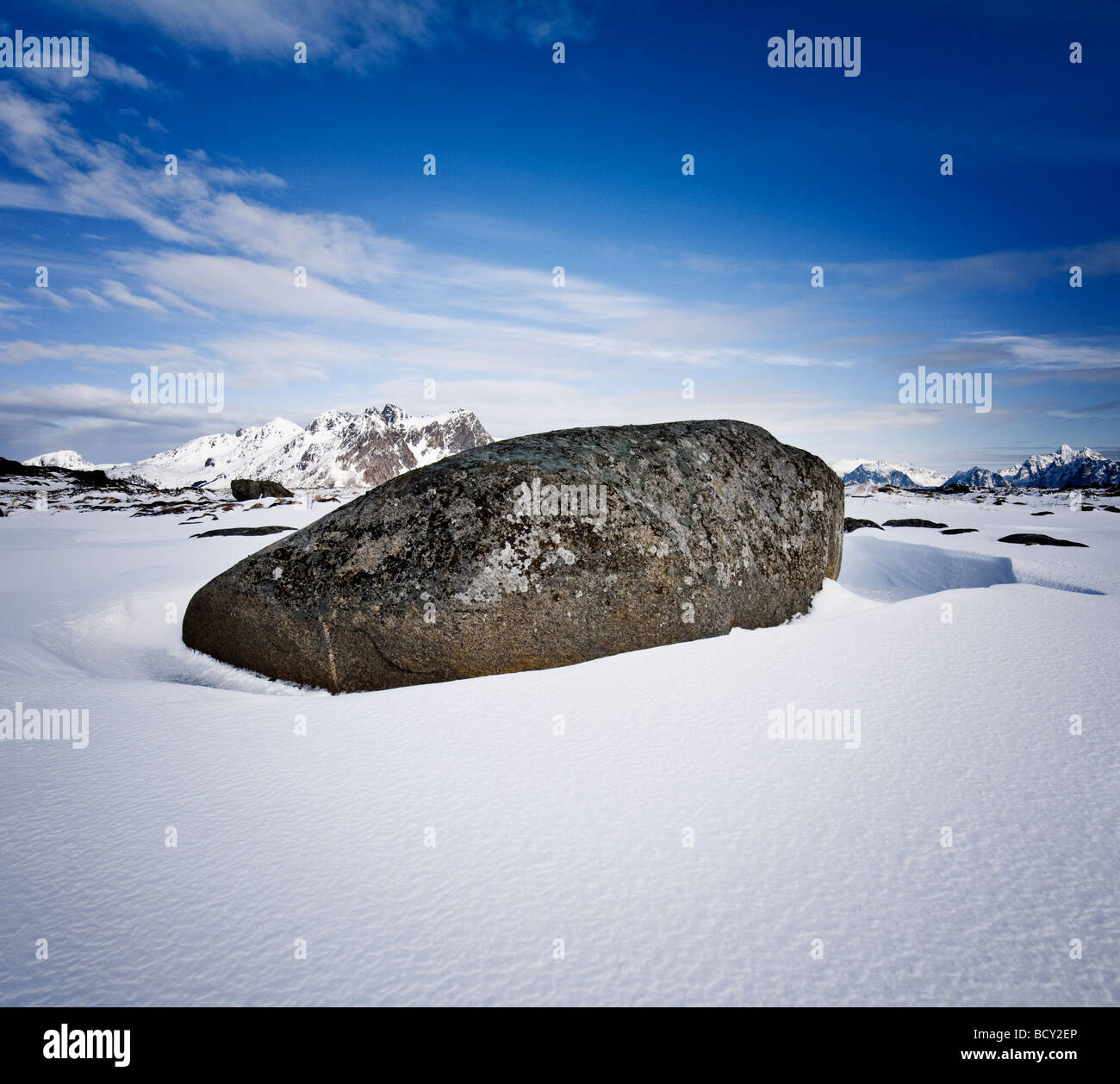 Large boulder in snow covered winter landscape, Near Stamsund, Vestvågøy, Lofoten islands, Norway Stock Photo