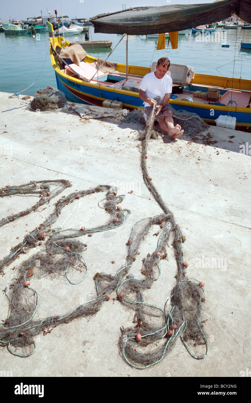 A Fisherman In Marsaxlokk Malta Works With His Nets In The Afternoon Sun Marsaxlokk Malta Stock Photo Alamy A Fisherman In Marsaxlokk Malta Works With His Nets In The Afternoon Sun Marsaxlokk Malta Stock Photo Alamy