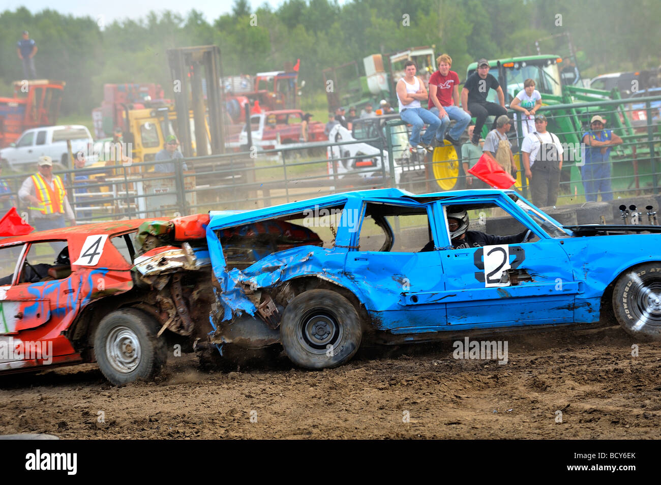 Spectators watch as two automobiles battle at a demolition derby Stock Photo