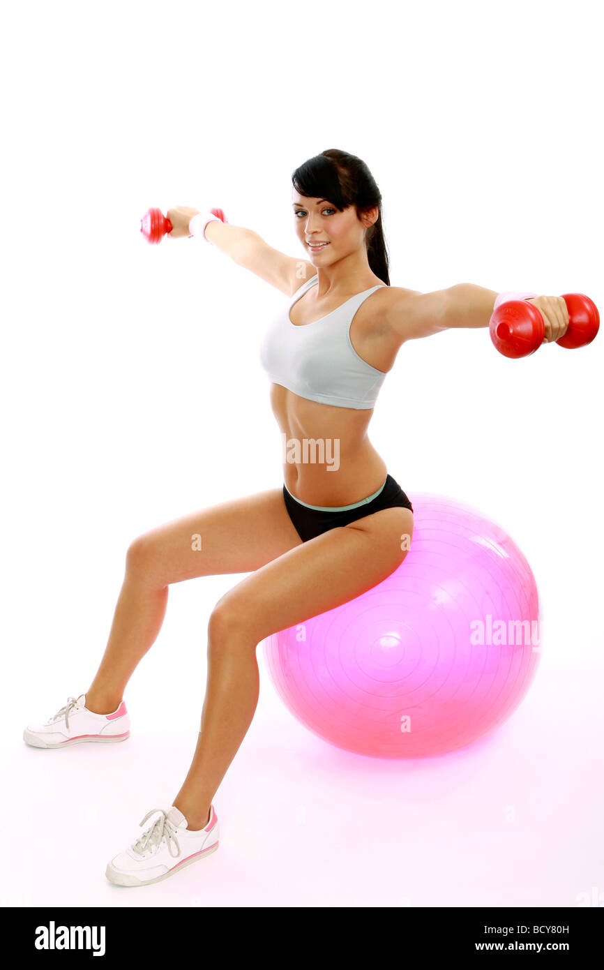 Frau bei Übungen mit einem Gymnastikball Woman exercising on a fitness ball  Stock Photo - Alamy