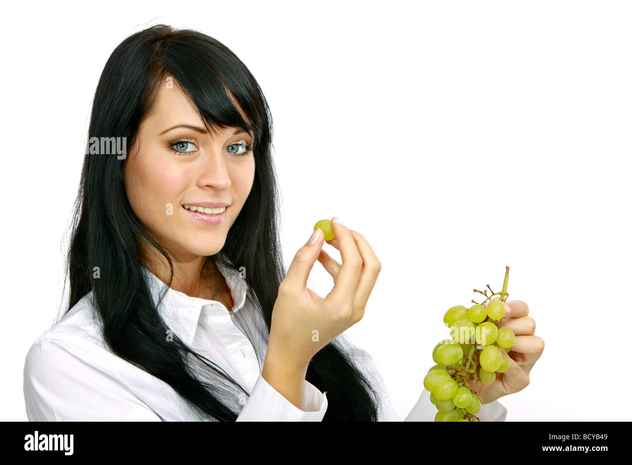 Junge Frau isst Weintrauben young woman eats grapes  Stock Photo
