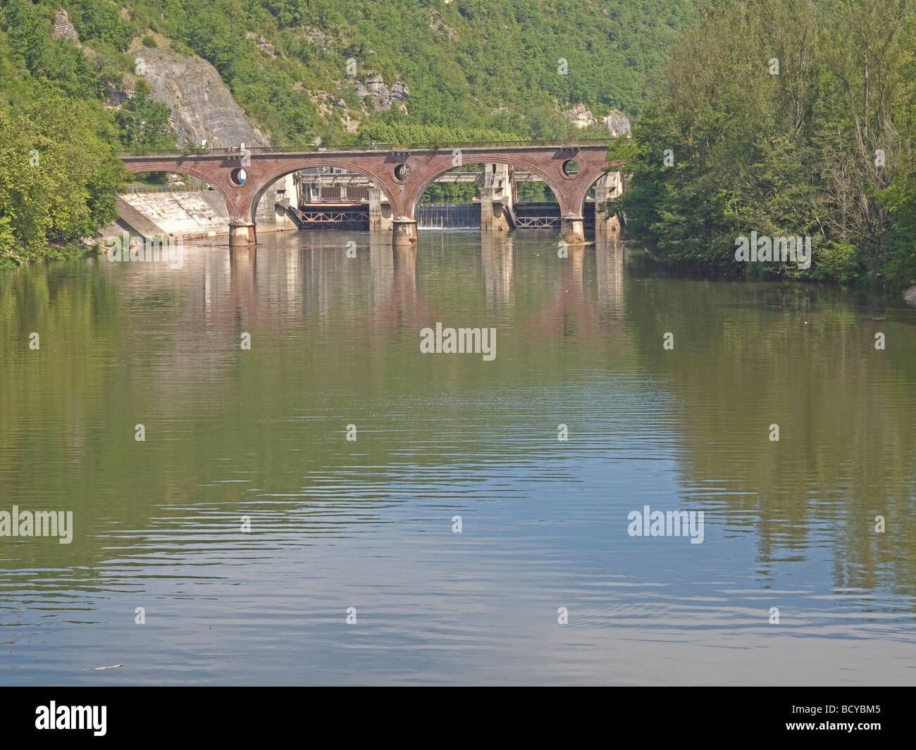 river Lot and the bridge in background mountain wih green trees by Castelfranc in France Stock Photo