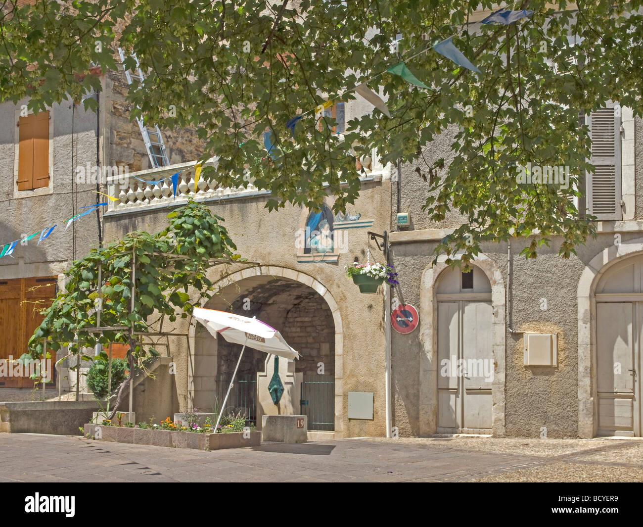 nice house with a picture and a fountain with arch and grapevine in Castelfranc in France Stock Photo
