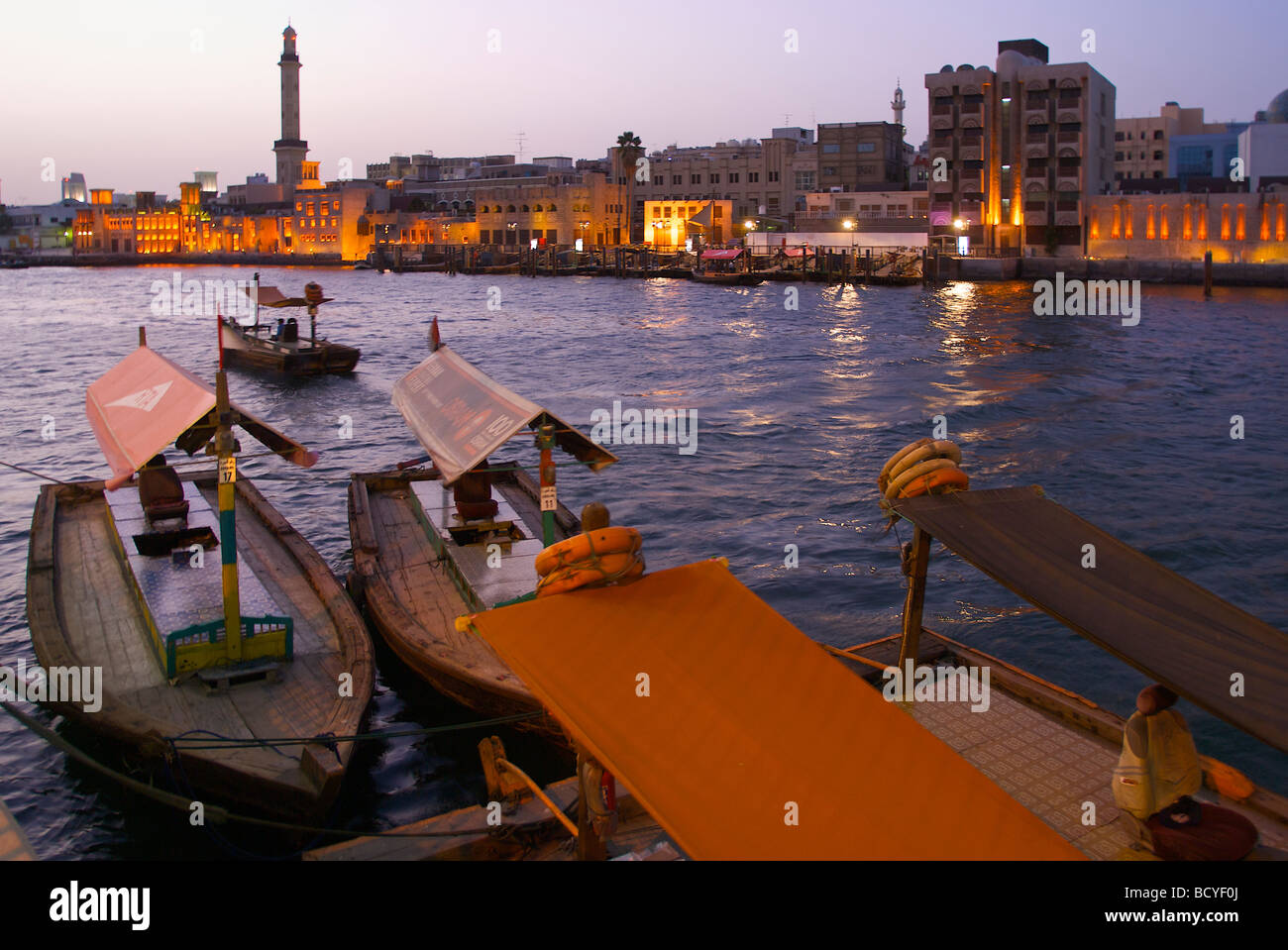 Water taxis (Abras) in the early morning at the Dubai Creek in Al Ras, Deira with view to the Bur Dubai waterside Stock Photo