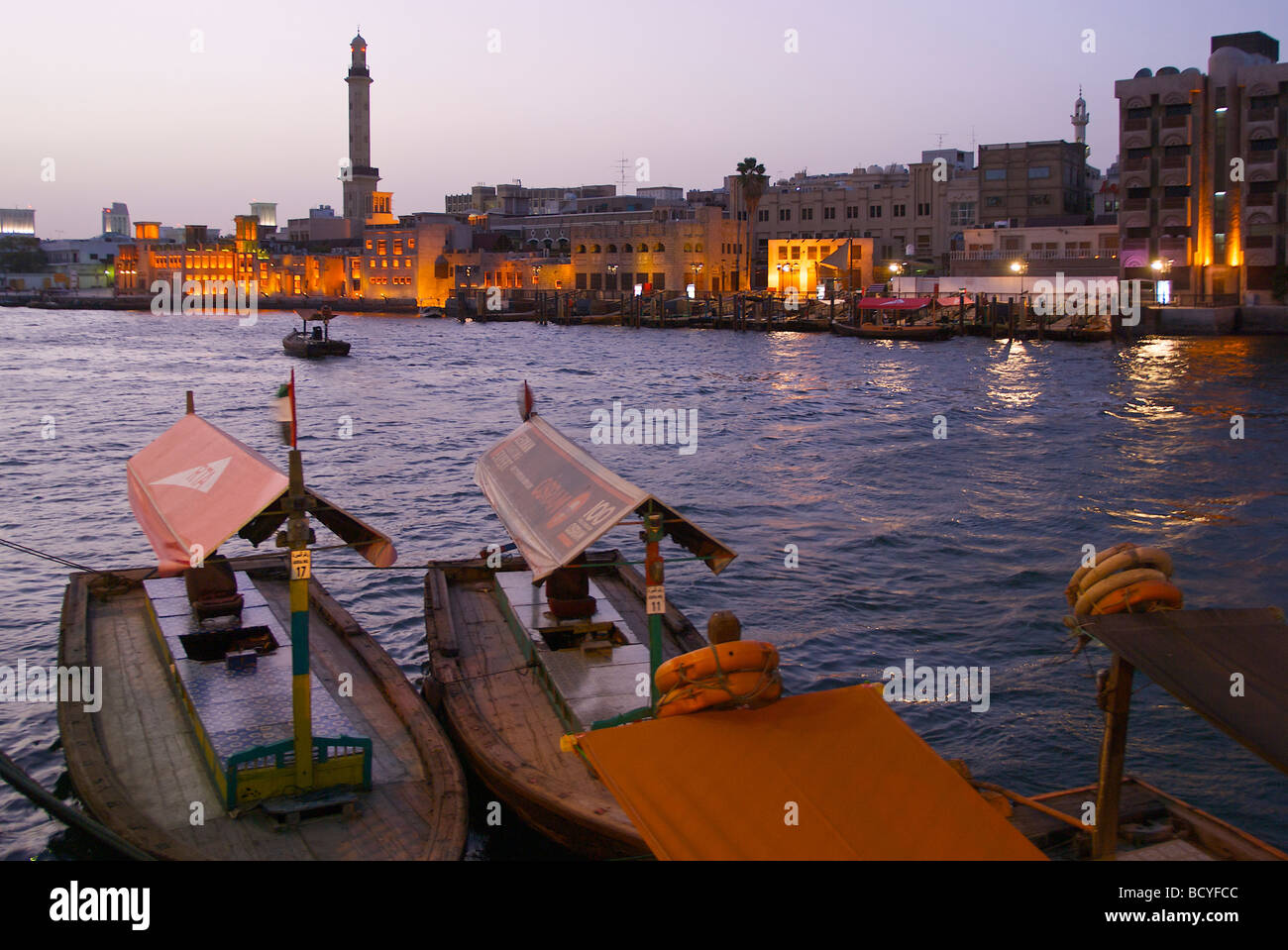 Water taxis (Abras) in the early morning at the Dubai Creek in Al Ras, Deira with view to the Bur Dubai waterside Stock Photo
