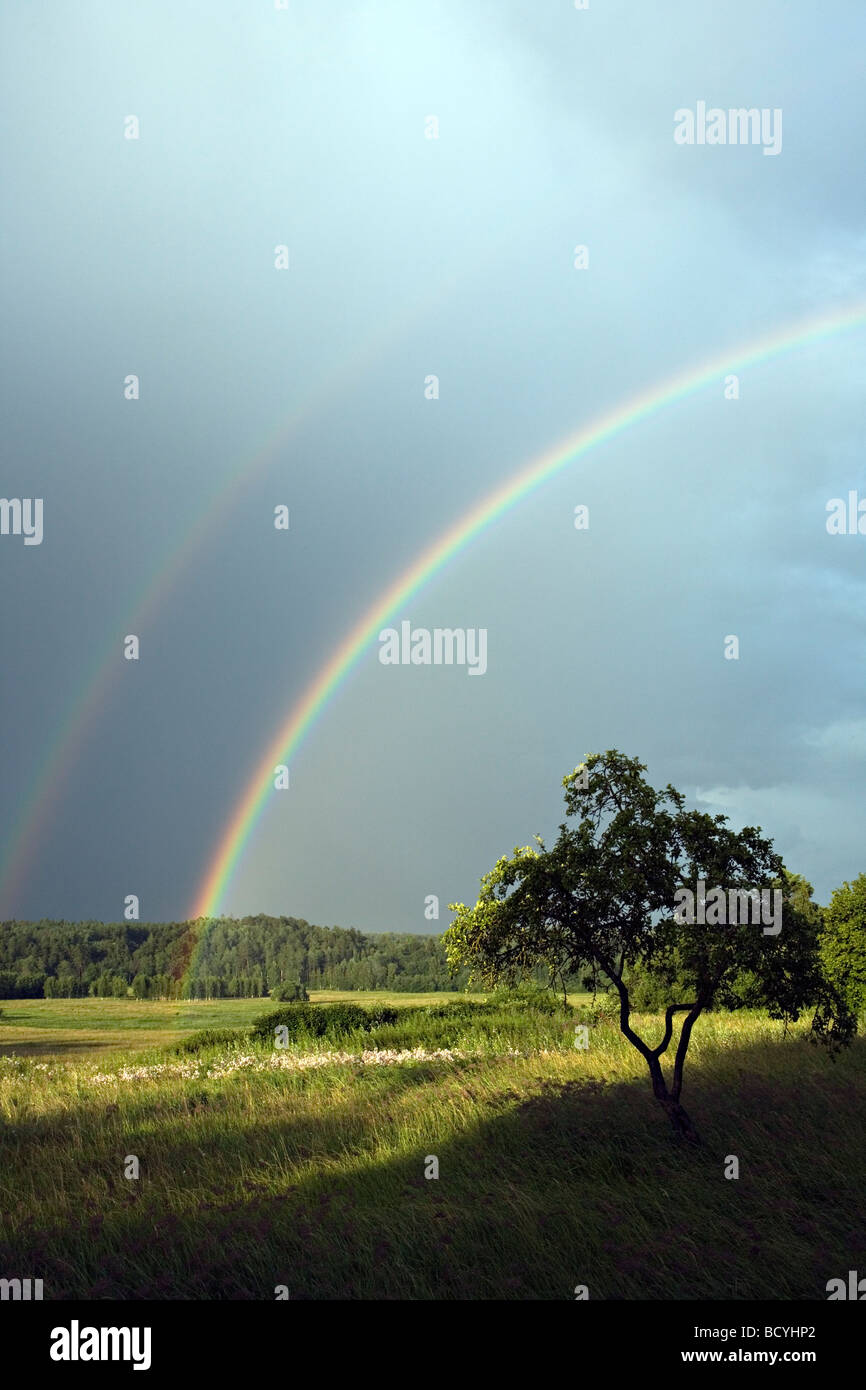 Bright primary and secondary rainbows over Gauja Valley, Gaujiena, Latvia Stock Photo