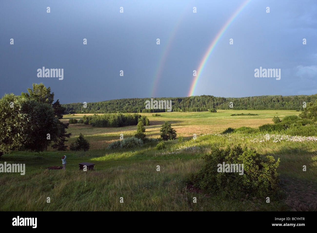 Bright primary and secondary rainbows over Gauja valley in Gaujiena Latvia Stock Photo