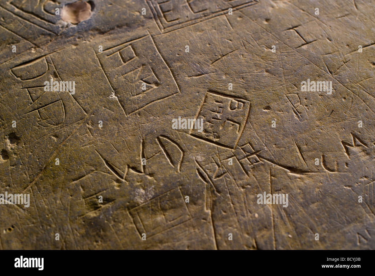 Initials carved into a slate slab by school pupils of the former Ardwyn Grammar school Aberystwyth Wales UK Stock Photo