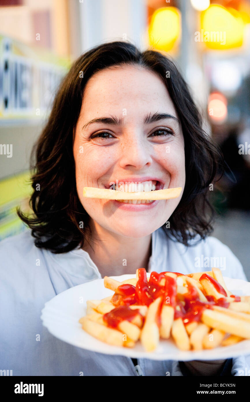 Woman Eating French Fries Stock Photo Alamy