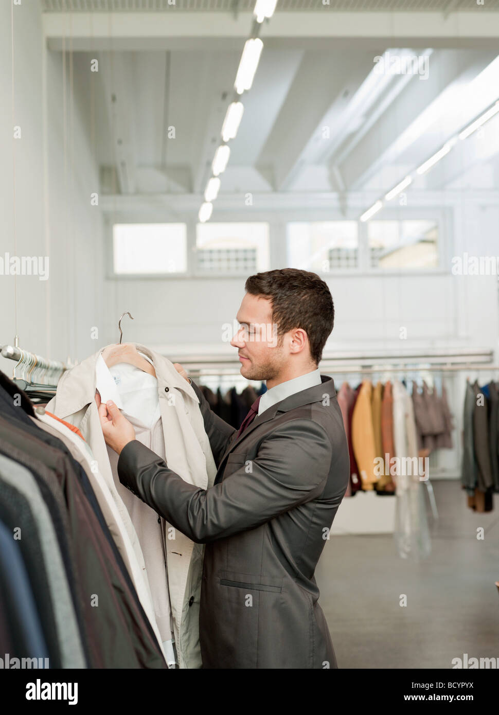 man shopping looking at jackets Stock Photo