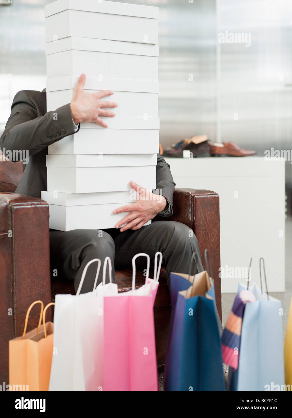 man shopping holding pile of cartons Stock Photo