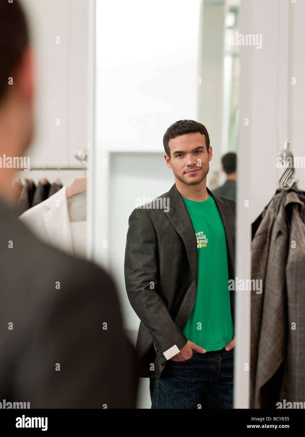 man looking at himself in mirror Stock Photo